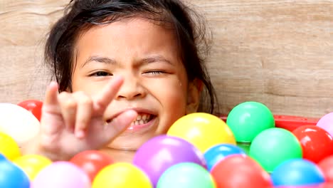 Thai-child-lift-her-hand--to-make-love-sign-language