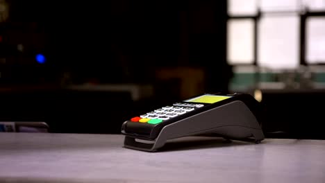 Close-up-shot-of-woman-attaches-hand-with-microchip-implant-to-terminal-performing-contactless-payment.