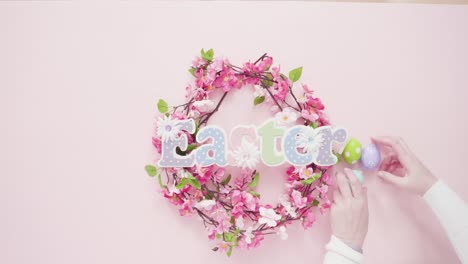 Easter-sign-with-flower-wreath-on-a-pink-background.