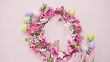 Easter-eggs-and-pink-flowers-on-a-pink-background.