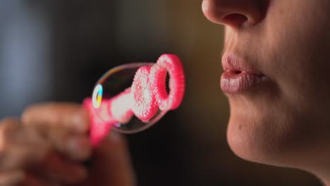 closeup-macro-slow-motion-lips-blowing-bubbles-from-pink-bubble-wand