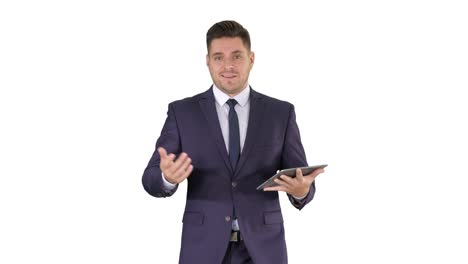 Businessman-swiping-pages-on-a-tablet-and-talking-to-camera-explaining-something-while-walking-on-white-background