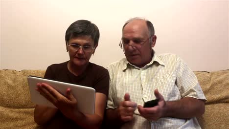 Attractive-adult-woman-and-adult-man-make-a-video-call-with-their-family-on-a-tablet-pc.