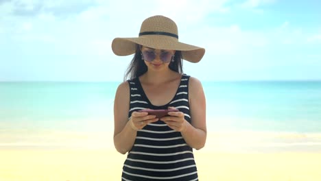 traveler-woman-using-phone-app-on-beach-at-summer-vacation.