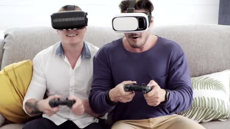 Schwules-Paar-entspannen-dan-auf-der-Couch-spielen-Virtual-Reality-Spiele.-Sehr-spannende-Action-Stimmung.