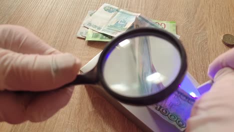 Verification-of-banknotes-by-an-ultraviolet-lamp-for-authenticity.