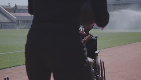 Wheelchaired-athlete-and-trainer-throwing-medicine-ball