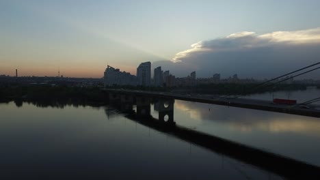 Drone-view-evening-city-landscape.-Aerial-view-car-traffic-on-suspension-bridge