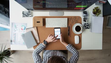 Busy-Businesswoman-Using-Smartphone-at-Workplace