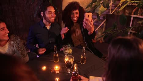 Close-up-black-couple-taking-selfie-with-smartphone-on-patio