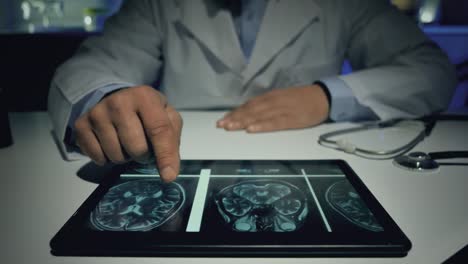 male-doctor-using-tablet-to-analyze-x-rays-brain-mri