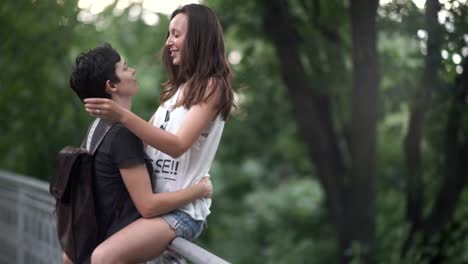 The-lesbian-sits-on-fence-and-kiss-girlfriend