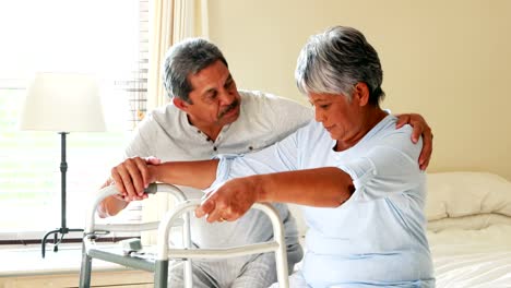 Senior-man-helping-woman-to-walk-with-a-walker-4k