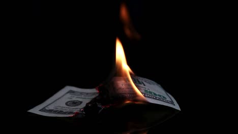 Dollar-bill-in-flames.-American-money-burning-on-black-background.