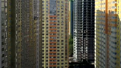 Aerial-view.-Urban-area-in-the-metropolis.-Construction-of-high-rise-residential-apartments-in-the-city.-Sale-and-rental-of-residential-real-estate.-Facade-of-the-house