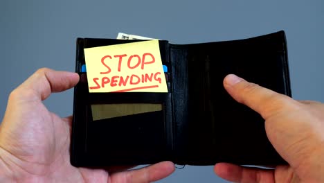 Man-opens-wallet-with-memo-Stop-spending.-Wasting-money-concept.