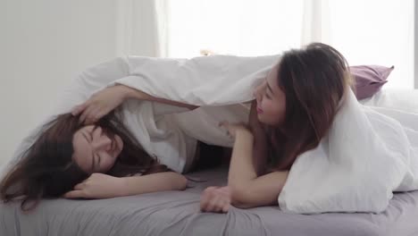 Beautiful-young-asian-women-LGBT-lesbian-happy-couple-hugging-and-smiling-while-lying-together-in-bed-under-blanket-at-home.-Funny-women-after-wake-up.-LGBT-lesbian-couple-together-indoors-concept.