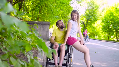 Young-disable-man-on-a-walk-in-the-park-with-his-wife