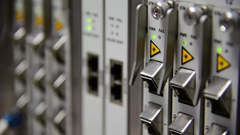 Networking-Temecommunication-fiber-optics-cable-patch-cord-connected-and-blinking-of-led-status-in-data-center