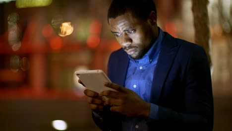 African-Man-Using-Tablet-Outdoors