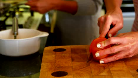 Lesbian-couple-preparing-food-in-kitchen-at-home-4k