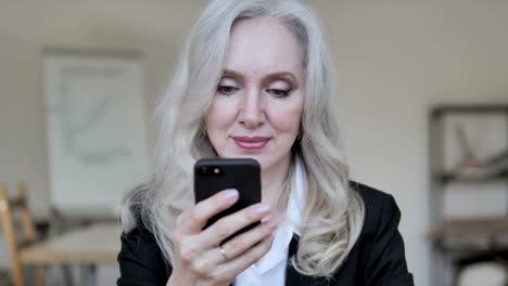 Businesswoman-Using-Smartphone-at-Work