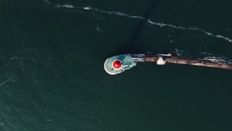 Aerial-top-view-of-white-lighthouse-near-sea-port