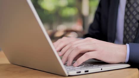 Hands-of-Businessman-Typing-on-Laptop