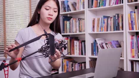 Woman-trying-to-fix-robot-at-home-alone.-Girl-having-talent-and-she-try-to-fix-robot-by-herself.-Technology-and-Education-concept.