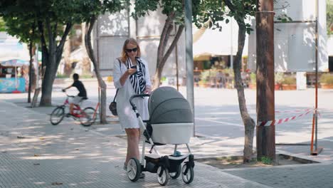 Woman-taking-selfie-and-photo-of-baby-during-the-walk