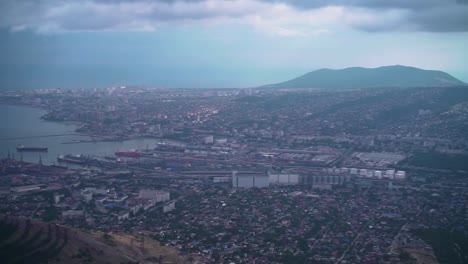 Footage-of-the-city-with-a-bay,-port,-buildings,-mountains.-Ariel-view-of-Novorossiysk.-Russia.