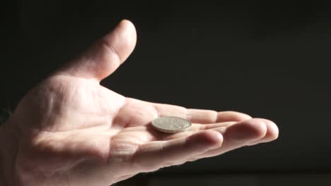 Hand-palm-up-holding-silver-Deutsche-Mark-coin.