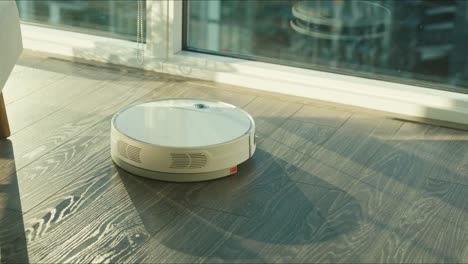 Close-up-of-the-robotic-vacuum-cleaner-riding-around-and-cleaning-up-apartments