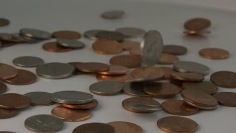 Super-slow-motion-of-a-bunch-of-coins-falling-on-a-table