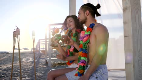 summer-holiday-on-tropical-island,-happy-guy-and-girl-on-beach-party-an-exotic-vacation,-woman-with-male-drink-alcohol-cocktail