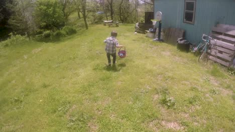 Small-little-boy-running-and-finding-Easter-eggs-and-putting-them-in-his-basket