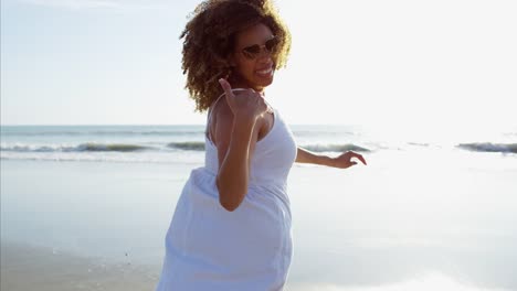 Portrait-of-African-American-female-running-through-waves