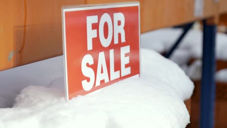 Stapel-von-orange-Lehmziegel-mit-Schnee-"For-Sale"-Wörter