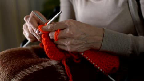 Female-shaking-hands-trying-knit,-concentrating-hobby,-parkinson-disease-symptom