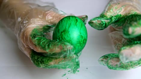 Paint-on-the-egg-with-hands