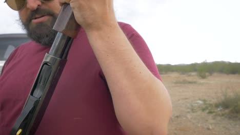 Handsome-Bearded-Man-Loading-Ammo-Shells-into-a-Shotgun-in-Slow-Motion