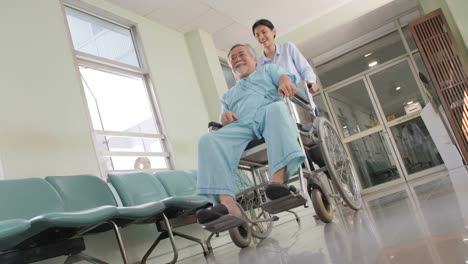 Beautiful-asian-young-women-walking-with-elderly-asian-men-patients-in-wheelchair