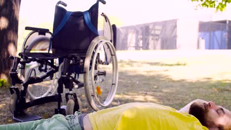 Young-disable-man-is-relaxing-on-the-ground-in-the-park