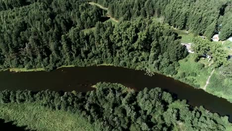 Aerial-beautiful-view-of-the-river-and-village-among-the-forest.