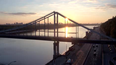 Aerial-shooting-pedestrian-bridge-of-Kiev-on-sunrise.-Summer-morning-in-Kiev-Dniepeer-river.-Ukraine.-European-city