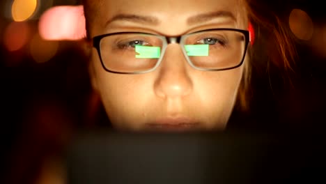 Portrait-of-young-beautiful-caucasian-woman-using-smart-phone-hand-hold-outdoor-in-the-city-night,-smiling,-face-illuminated-screenlight---social-network,-technology,-comunication-concept