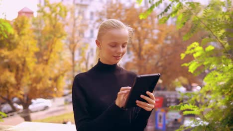 portrait-caucasian-woman-use-digital-tablet-outdoors