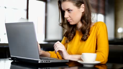 Female-blogger-working-on-laptop-in-cafe,-posting-publication-in-social-network