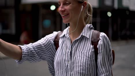 Slow-motion-effect-of-cheerful-travel-blogger-in-electronic-earphones