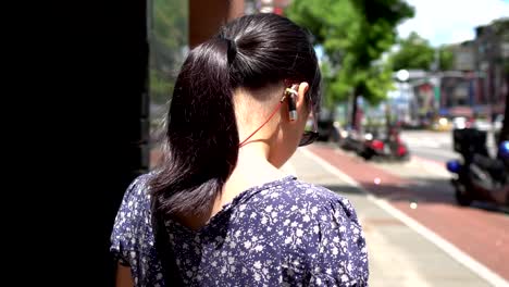 The-Hearing-loss-child-with-sunglasses-is-waiting-for-the-bus-at-the-bus-stop.